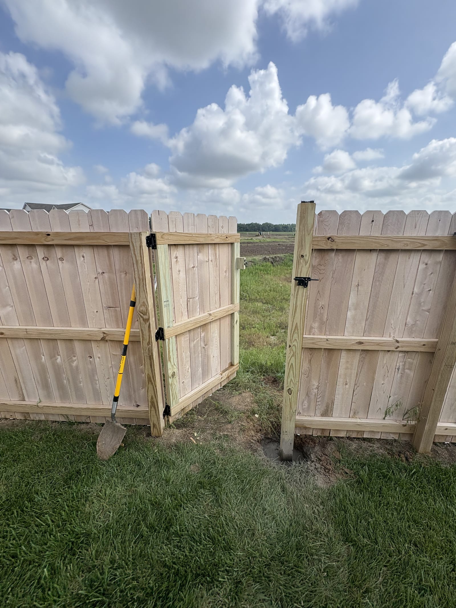 Newly built wood privacy fence with a matching gate in Manhattan, KS