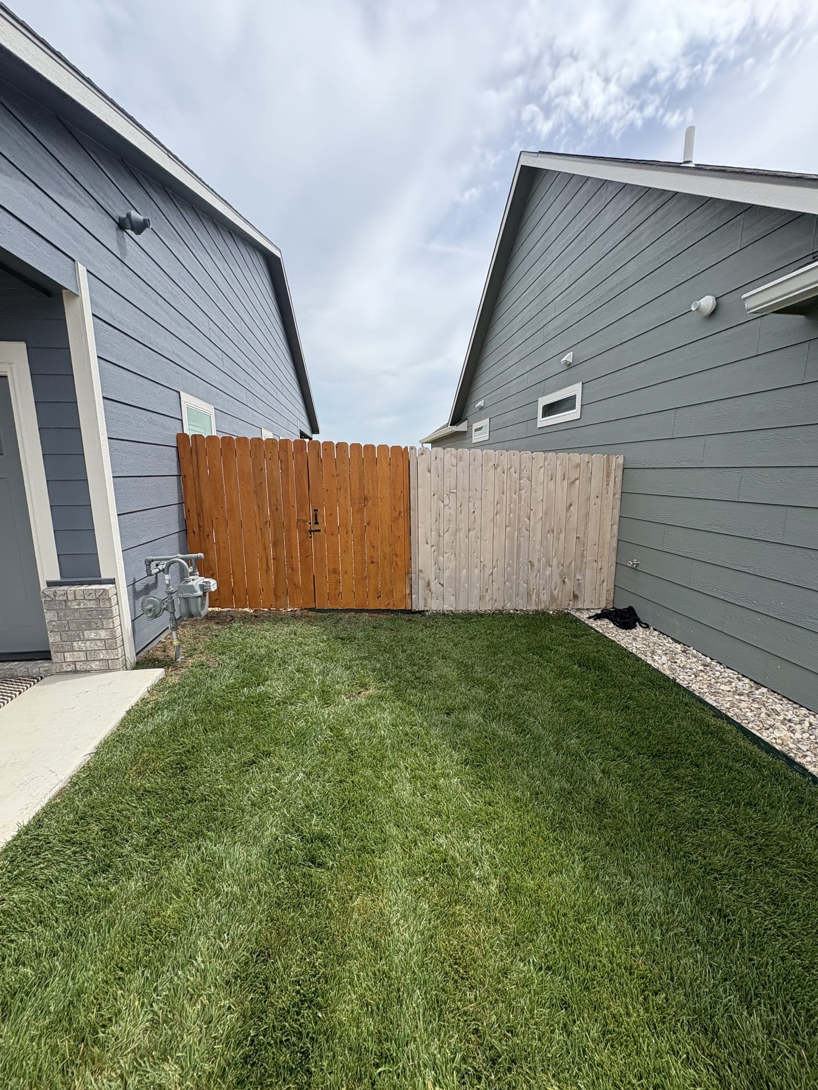 Freshly stained wood fence, view two