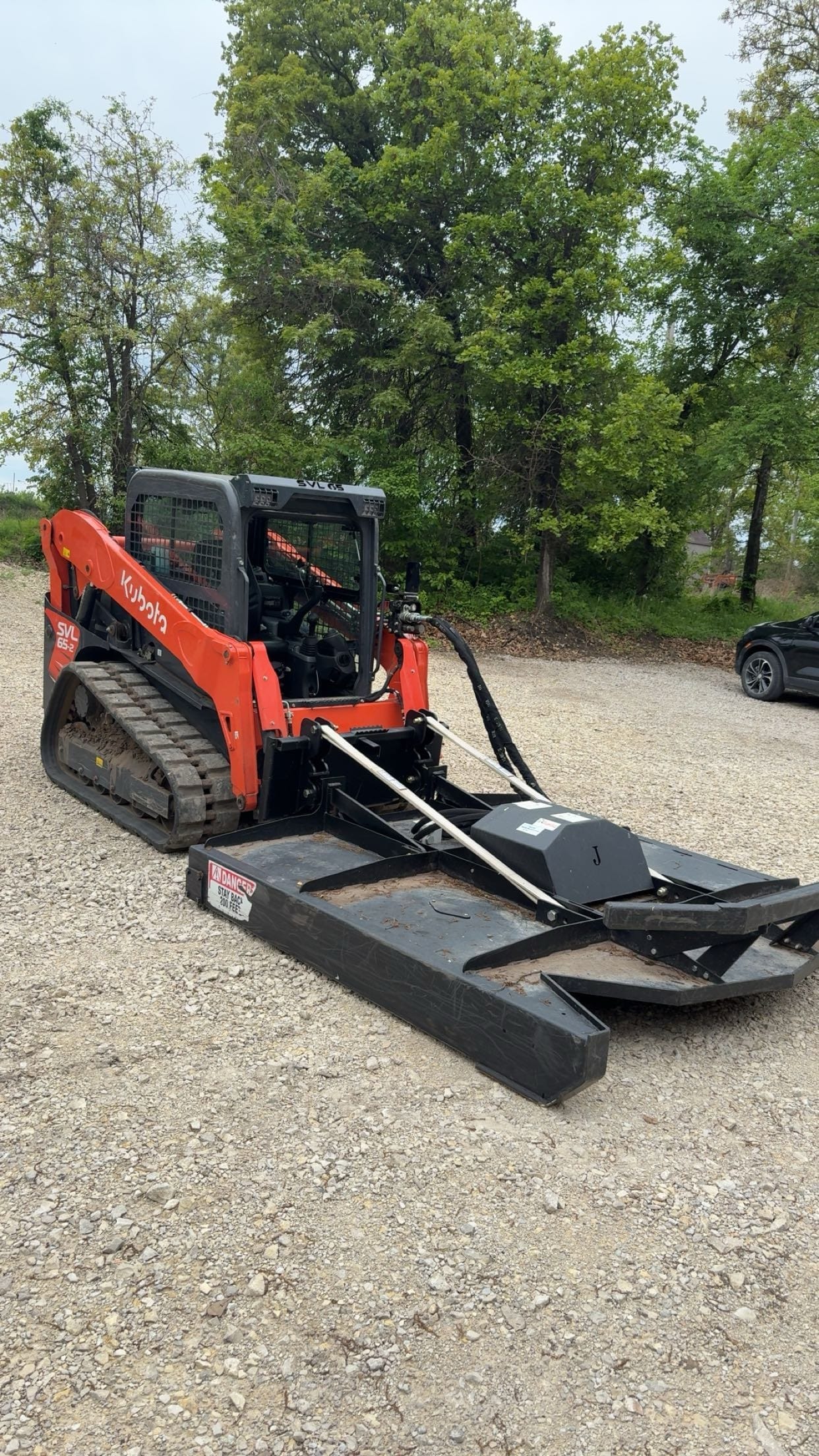Brush hogging in progress on overgrown acreage